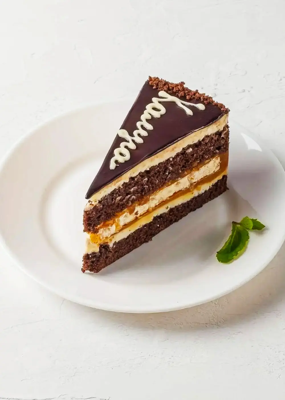 Кусок торта Калуга на белой тарелке